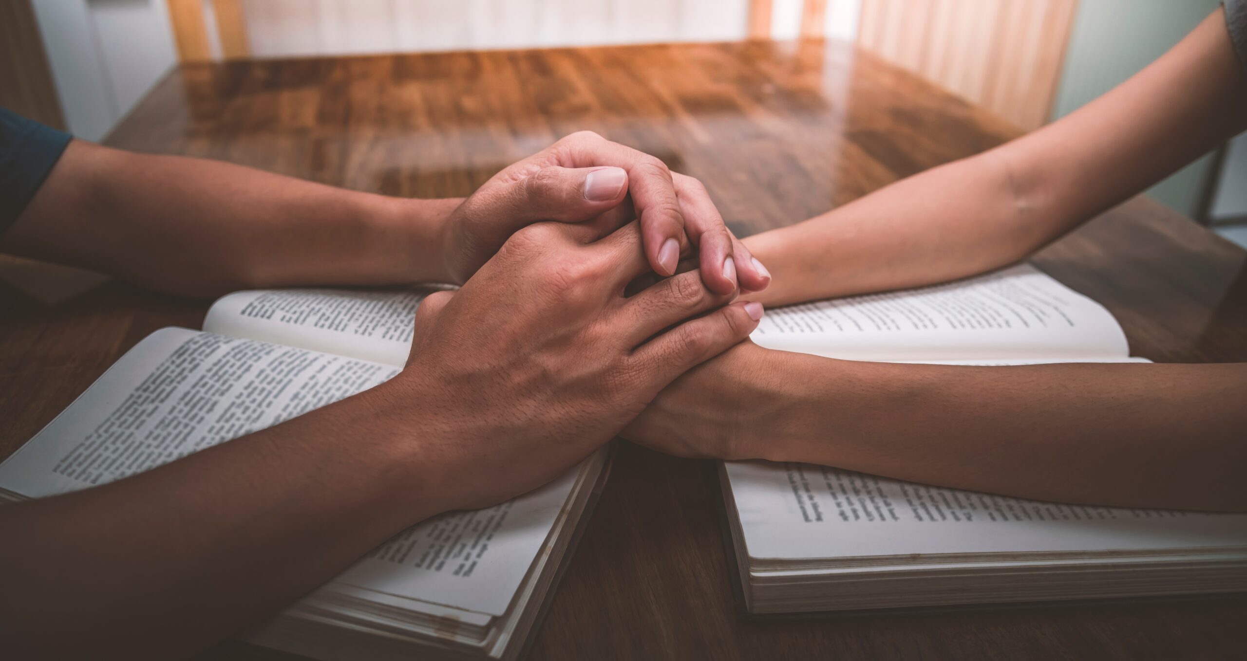 Husband,And,Wife,Join,Hands,And,Pray,Together,On,Table, Family prayer time Christian marriage faith